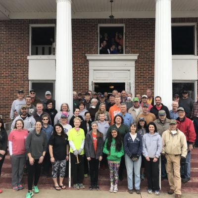 Approximately 70 people standing on the steps of the old sanctuary